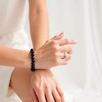 The bracelet is demonstrated by the model